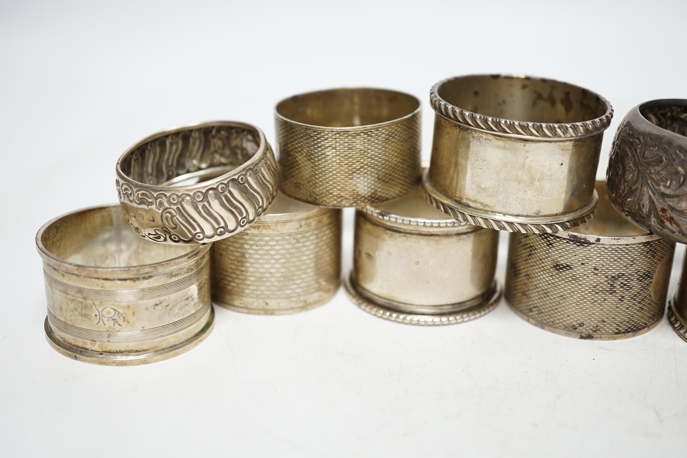 Eleven assorted early 20th century and later silver napkin rings, various dates and makers, 9.2oz. Poor to fair condition.